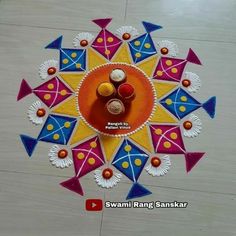 an artistic design made with colored paper on the floor for diwaling and decorating