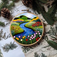 an embroidery project with flowers and trees on it