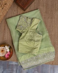 "The Pure Organza Pastel Green Saree Is A Delicate And Elegant Piece Of Clothing That Exudes Grace And Sophistication. The Subtle Pastel Green Base Adds A Touch Of Refinement To The Saree, Making It Perfect For Formal Occasions. The Saree Is Adorned With All-Over Hand Embroidery Over The Borders With Fine Threads Of Golden And Silver, Which Add A Touch Of Shimmer And Shine To The Saree. The Blouse That Comes With The Saree Is Heavily Embroidered , Which Perfectly Complements The Intricate Embroi Pastel Green Silk Saree, Pastel Green Saree, Green Silk Saree, Green Saree, Shimmer And Shine, Pretty Blouses, Shimmer N Shine, Green Silk, Pastel Green