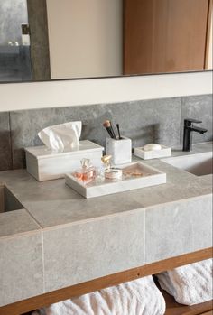 a bathroom counter with soaps and other items on it