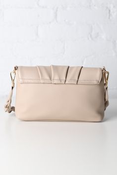 Discover the perfect blend of style and practicality with our Vegan Leather Crossbody. The foldover flap secured by a magnetic snap, along with ruched details, adds a touch of sophistication. The versatility of the braided detachable shoulder strap and adjustable crossbody strap makes this bag an ideal companion. Organize your essentials effortlessly with the fabric-lined interior featuring a zip pocket and slip pocket. Item Type: Crossbody Material: Vegan Leather Closure: Foldover Flap with Mag Beige Shoulder Bag With Fold Over Clasp For Travel, Chic Satchel With Fold Over Clasp And Flap, Versatile Clutch Shoulder Bag With Fold Over Clasp, Chic Beige Shoulder Bag With Fold Over Clasp, Beige Flap Bag With Magnetic Closure For Travel, Beige Travel Bag With Fold Over Clasp, Beige Flap Bag With Magnetic Closure, Beige Clutch Bag With Fold Over Clasp, Beige Flap Bag With Magnetic Closure For Evening