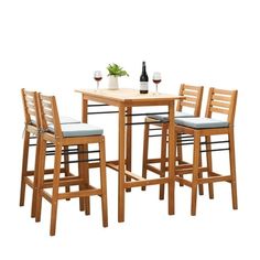 a wooden table with four chairs and a bottle of wine