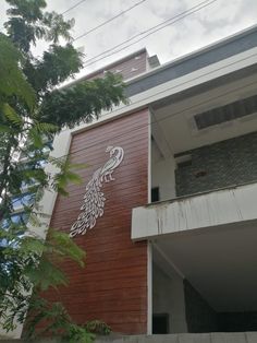 the side of a building with a peacock painted on it