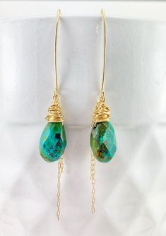 "These one of a kind drop earrings are lightweight and dazzling. Perfect for a night on the town combining comfort and glam. Measuring in at nearly 3\" from top to bottom they are the perfect addition to any outfit. Boho wire wrapping and chain in 14 k gold fill compliment the intense turquoise greens and blues. PLEASE NOTE: While these earrings are custom made from the same gorgeous strand of turquoise they will look a little different. They are carefully wire wrapped especially for you! They a Turquoise Bohemian 14k Gold-filled Earrings, Turquoise 14k Gold Filled Bohemian Earrings, Bohemian Turquoise 14k Gold-filled Earrings, Bohemian Turquoise 14k Gold Filled Earrings, Turquoise Gold Bohemian Earrings, Turquoise Wire Wrapped Teardrop Dangle Earrings, One Of A Kind Gold Teardrop Earrings, Turquoise 14k Gold Filled Drop Earrings, Turquoise 14k Gold-filled Earrings With Ear Wire