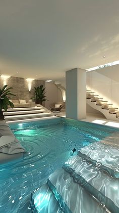 an indoor swimming pool with steps leading up to the upper floor and stairs in the background