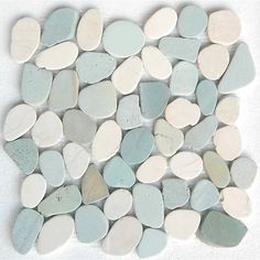 a pile of white and blue pebbles sitting on top of a table