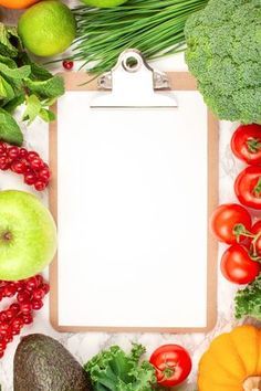 a clipboard surrounded by fruits and vegetables