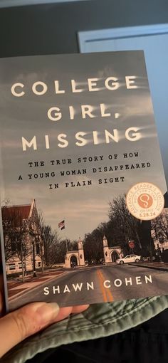 a person holding up a book about college girl missing