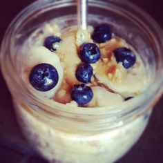 a jar filled with oatmeal and blueberries