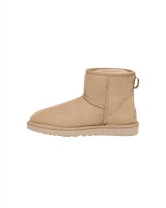 Born on the beaches of California, our Classic Boot was originally made to keep surfers warm after early-morning sessions and has since become an icon of West Coast cool. It's crafted with our famously soft sheepskin, which naturally wicks away moisture so you can wear it anywhere – both indoors and out. This product was made in a factory that supports women in our supply chain with the help of HERproject, a collaborative initiative that creates partnerships with brands like ours to empower and Ugg Classic Mini Ii, Ugg Classic Mini, Ugg Classic, Classic Boots, Sand Color, Classic Mini, Real Fur, Women Supporting Women, Supply Chain