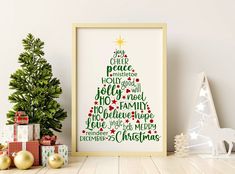 a christmas tree is displayed in front of presents on the shelf next to a framed poster