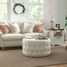 a living room with couches, chairs and a coffee table in front of a window