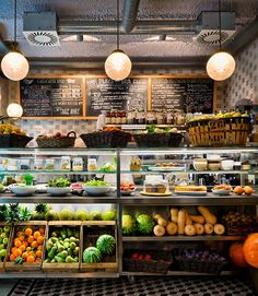 a display case filled with lots of fresh fruits and vegetables