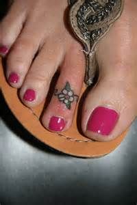 a close up of a person's feet with pink nail polish