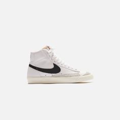 WMNS Blazer Mid 77 silhouette  Leather upper  Suede overlays  Padded collar   Nike logo on exposed foam tongue  Swoosh on side panels  Nike branding on rear  Flat cotton laces  Rubber outsole    Style: NKCZ1055-100 Color: Vintage White / Black / Sail Material: Leather Blazer Mid 77 Vintage, Womens Footwear, Blazer Mid, Nike Sneakers Women, Color Vintage, Newest Jordans, Clarks Originals, Socks And Sandals, Leather Shops