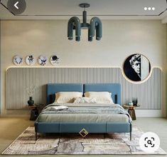 a bedroom with a large bed and blue headboard on the wall next to a round mirror