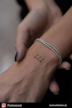 two people holding each other's hands with the word love tattooed on their arm