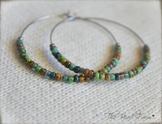 "Large hoop (1.75\") Boho Hippie Style Beaded Hoop Earrings in beachy color blend Super lightweight Boho Hippie style hoop earrings. The 1.75\" circle hoops are 316 stainless steel memory wire. The 8/0 tiny beads are colors of the surf and sand. Great for the beach or wherever! *Looking for supplies to make your own boho jewelry? Check out my other etsy shop (BeadnFarm Stuff) for beading supplies. https://www.etsy.com/shop/BeadnFarmStuff LIKE me on Facebook! https://www.facebook.com/beadnfarm Ab Green Bohemian Hoop Earrings Hypoallergenic, Bohemian Green Hoop Earrings Hypoallergenic, Bohemian Green Hypoallergenic Hoop Earrings, Farm Jewelry, Beachy Colors, Boho Hippie Style, Tiny Beads, Beaded Hoop Earrings, Beaded Hoops