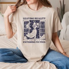 Leaving Reality Entering Fiction T-Shirt, Bookish Shirt, Retro Book Shirt, Book Lover Tee, Bookworm Shirt, Reader, Book Club, Booktrovert  HOW TO ORDER 1-) Please, check and review all photos 2-) Choose your item size and color 3-) Click add to cart. You can go back to add more product 4-)Click "Proceed to check out" 5-)When you check out, you can add a note to seller for any request PRODUCT FEATURE It's a 50% Cotton /50% polyester, 13.5oz fleece. It features a double-needle collar, shoulders, a Book Worm Outfit Aesthetic, Relaxed Fit Graphic Print Shirt With Bookish Style, Relaxed Fit Graphic Print Shirt In Bookish Style, Literary Cotton Relaxed Fit T-shirt, Literary Style Cotton T-shirt With Relaxed Fit, Literary Crew Neck T-shirt With Screen Print, Literary Relaxed Fit Crew Neck T-shirt, Screen Print Crew Neck T-shirt, Bookish Outfits