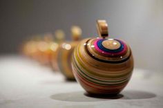 several colorful vases are lined up on the floor in a row and one is empty