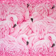 a group of pink flamingos sitting on top of glitter covered ground