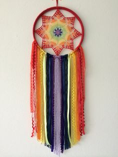 a multicolored dream catcher hanging on the wall