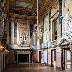 the inside of an ornate building with chandeliers