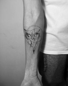 a man's arm with an owl tattoo on the left side of his arm