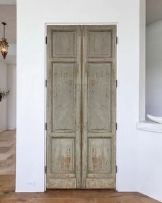 an old wooden door in a white room