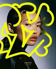 a woman with black hair and neon yellow letters on her face