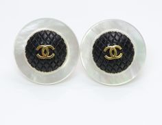 Vintage Chanel CC Mother of Pearl Quilted Earrings Limited edition Chanel 1980’s earrings. Mother of pearl clip-on earrings with gold tone CC logo on a quilted black background. Approximate Diameter: 1.5” Made in France Condition: Very Good Thanks for viewing this item: we have more Chanel jewelry here. To find out more about Chanel's history please visit our blog. Quilted Earrings, Genuine Love, Chanel Jewelry, Chanel Paris, Black Quilt, Cc Logo, Vintage Chanel, Black Background, Black Backgrounds