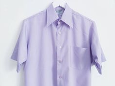 Lilac blouse, Ladies dress shirt, Button Down Shirt, Short sleeve shirt, Solid blouse, blouse with pocket, Vintage blouse, Lilac top, Size L Good vintage condition Need to be ironed Measurements (lying flat): Pit to pit 22''/56cm Length 30''/76cm Sleeve length 10''/25cm Please check measurements to insure a proper fit. Remember to allow yourself some extra room for movement. You can compare measurements with something from your closet that fits you well. Please feel free contact me if you need additional measurements or have any questions! This blouse will come to you freshly laundered and ready to wear. SHIPPING * I ship from Europe (Latvia), so please allow 2 to 4 weeks for the package to arrive if you live overseas. * Europe 1 to 2 weeks. For courier delivery please send me your full ph Office Shirt With Pockets And Short Sleeves, Short Sleeve Office Blouse With Pockets, Semi-formal Shirt With Spread Collar And Pockets, Formal Short Sleeve Tops With Pockets, Classic Short Sleeve Dress Shirt For Spring, Solid Color Short Sleeve Dress Shirt For Spring, Solid Short Sleeve Dress Shirt For Spring, Lapel Collar Shirt For Daywear, Summer Short Sleeve Dress Shirt For Work