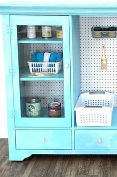 a blue cabinet with shelves and baskets on it