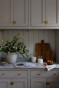 a kitchen counter with flowers and eggs on it