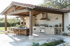 an outdoor kitchen and dining area is shown