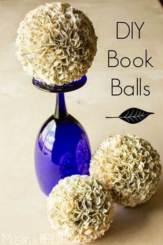 three blue vases with flowers in them sitting on a wooden table next to the words diy book balls