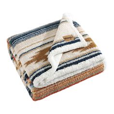 the multicolored blanket is folded on top of each other, with a white and brown