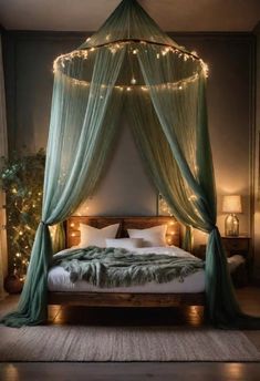 a canopy bed with lights hanging from it's sides and pillows on the floor