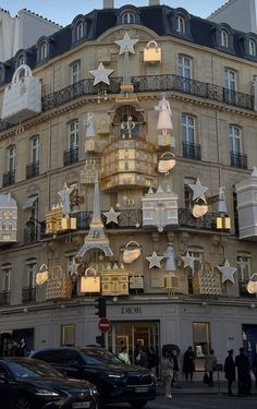 a building with christmas decorations on the front and side of it's windows in paris, france