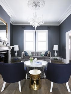 a living room filled with furniture and a chandelier