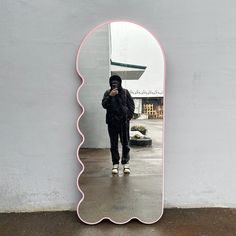 a person standing in front of a large mirror