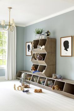 a child's room with toys and bookshelves