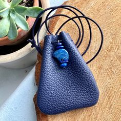 "Leather Medicine Bag, Shaman Bag or Amulet Pouch to wear around your neck-or hang in your Car! Perfect for Ceremony or to wear to a Festival...or even to wear everyday! Evening Sky Blue Leather with gorgeous and rare Lapis Lazuli Bear Totem. AND a Soft,Teal Leather with Blue Apatite Stones. A Unique and Beautiful Gift . A place for things that have Spiritual Meaning for you-like that pretty rock your 3 year old gave you.... 3 3/4\"deep 2 3/4\"wide Leather cord is about 38\"long(cut out length) Handmade Blue Coin Purse For Travel, Blue Adjustable Necklace For Everyday Use, Handmade Blue Necklace For Everyday Use, Handmade Blue Necklace For Everyday, Blue Handmade Necklace For Everyday Use, Blue Bohemian Necklaces For Everyday Use, Bohemian Blue Necklaces For Everyday Use, Handmade Blue Coin Purse For Gift, Blue Portable Coin Purse For Gift