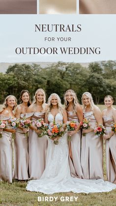 a group of women standing next to each other in front of an outdoor wedding sign