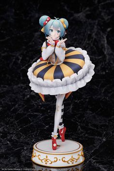 an anime figurine is posed on top of a stand with her hands clasped