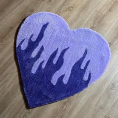 a heart shaped rug with purple paint on it