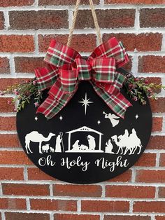 a christmas sign hanging on the side of a brick wall