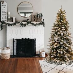 a living room with a christmas tree in the corner and a mirror on the wall