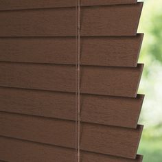 a close up view of the outside of a window with wood blinds in front of it