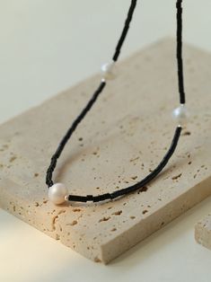 Elevate your style with our Minimalist Modern Pearl and Black Onyx Beaded Necklace. This sleek and sophisticated piece features natural black onyx beads, elegantly complemented by iridescent freshwater pearl accents. The classic black and white color scheme exudes a sense of high fashion and timeless elegance. Perfectly balancing simplicity with chic sophistication, this necklace is a versatile staple for any wardrobe. Metal: Recycled Sterling Silver Plated On Brass Gemstone: Black Onyx,Freshwater Pearl 8.5-9mm Length: 400-450mm Weight: 8.8g Black Pearl Necklace With Pearl Charm, Black Pearl Drop Necklace, Black Pearl Necklace With Round Beads And Pearl Drop, Black Pearl Drop Necklace With Round Beads, Elegant Black Beaded Necklace With Pearl Charm, Black Pearl Necklaces With Pearl Charm, Black Pearl Necklace With Round Beads, Black Minimalist Jewelry With Pearl Charm, Minimalist Black Pearl Drop Jewelry